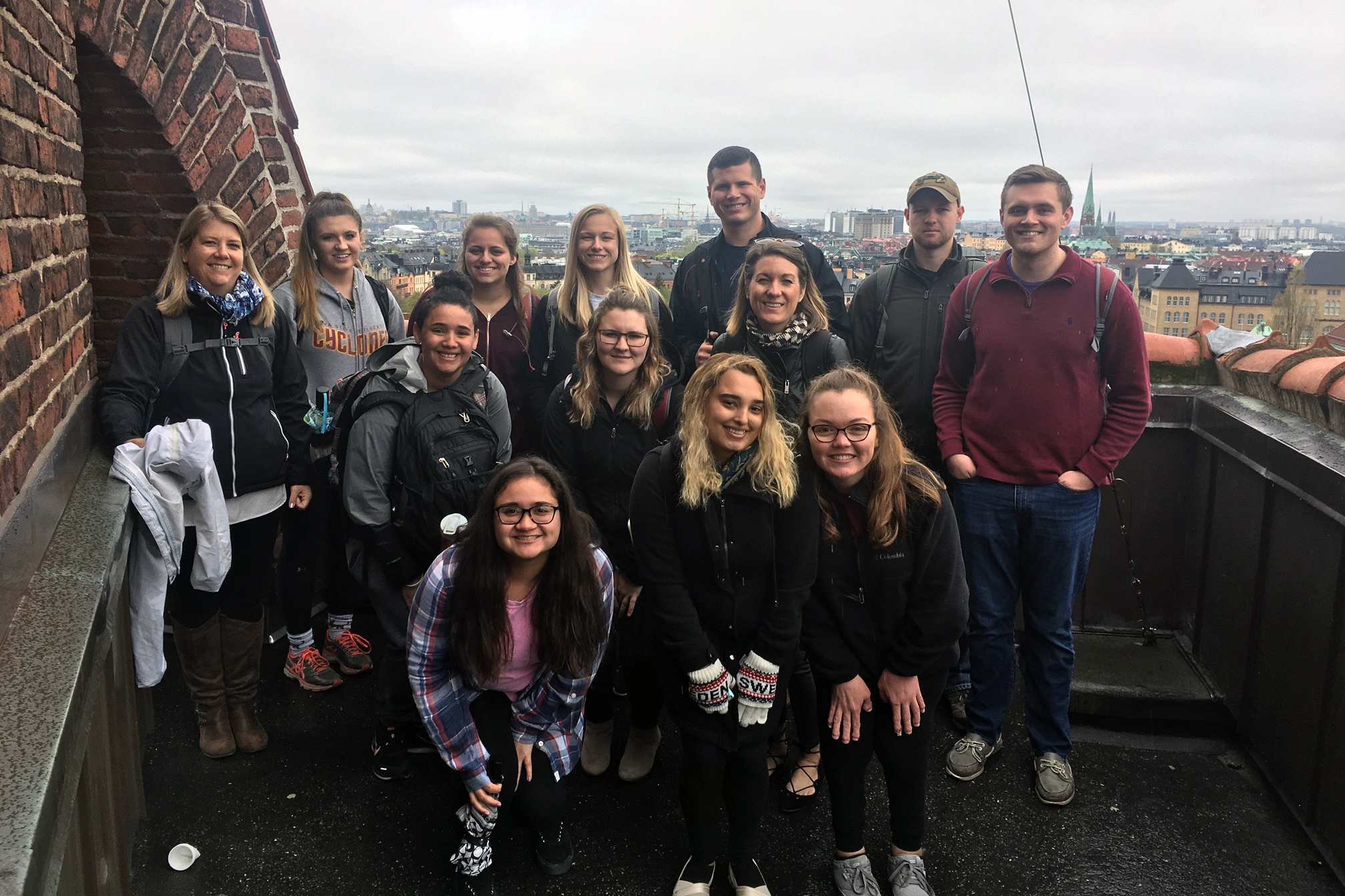 Students and faculty take in the view from the rooftop of a campus building at KTH, Iowa State's partner university in Stockholm, while on a walking tour.