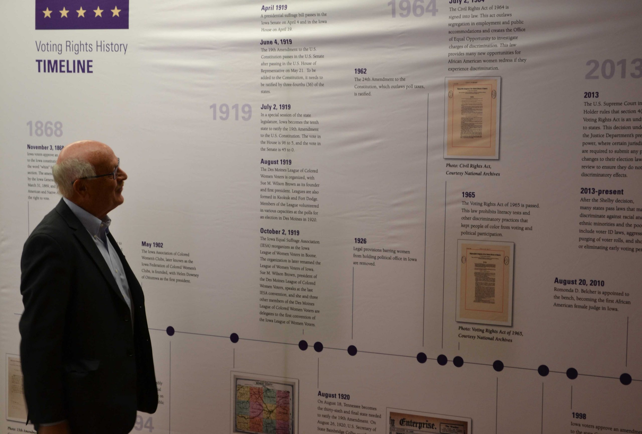 Visitor at the Feb. 14 kickoff reading the timeline in the 'Toward a Universal Suffrage' display