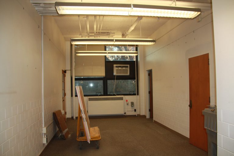 Existing office with furniture and wall decorations removed.