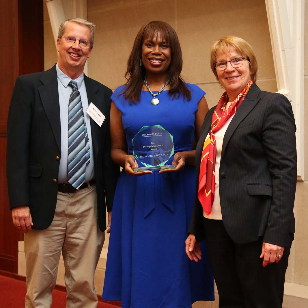 Dr. Kandis Boyd Wyatt (center) poses with Dr. William Gallus (left) and Dean Beate Schmittmann (right).