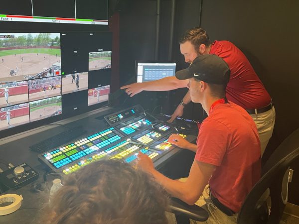 High school student learning how to use a video production board.