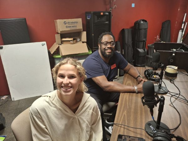 Greenlee School of Journalism and Communication student Marijke Mendeszoon and Greenlee assistant professor of journalism Tony Moton prep for an airing of "Miki's Sports Minutes" on 88.5 KURE Ames Alternative radio station.