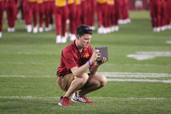 Student Kneeling on Football Field