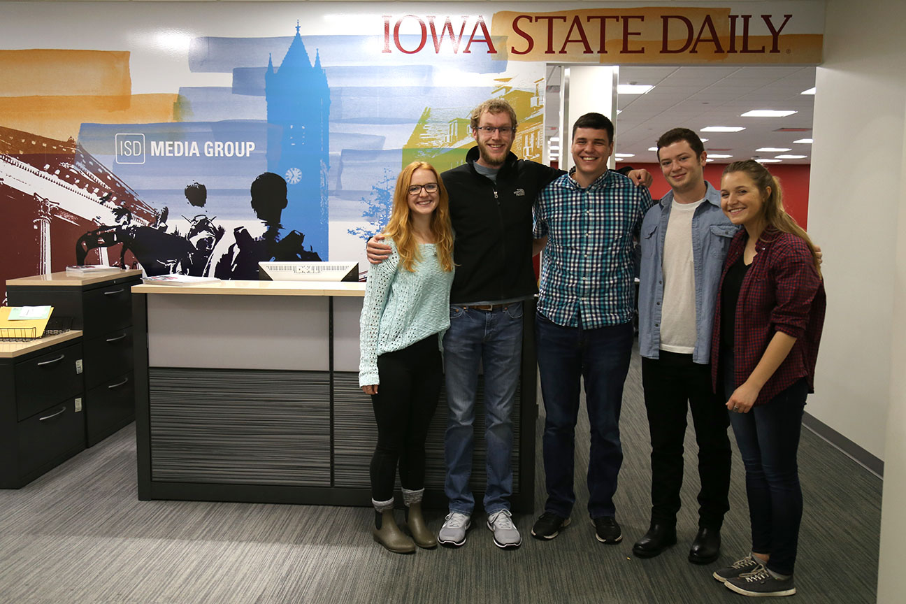 Five students, two female and three male, standing in the Iowa State Daily.