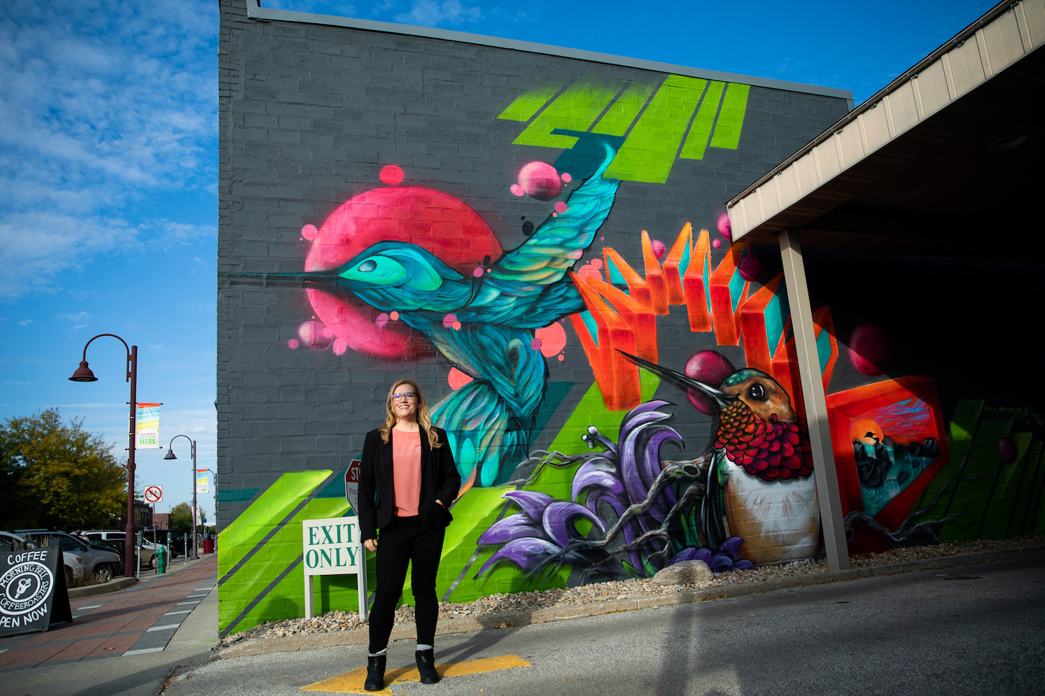 Dara Wald in front of colorful mural