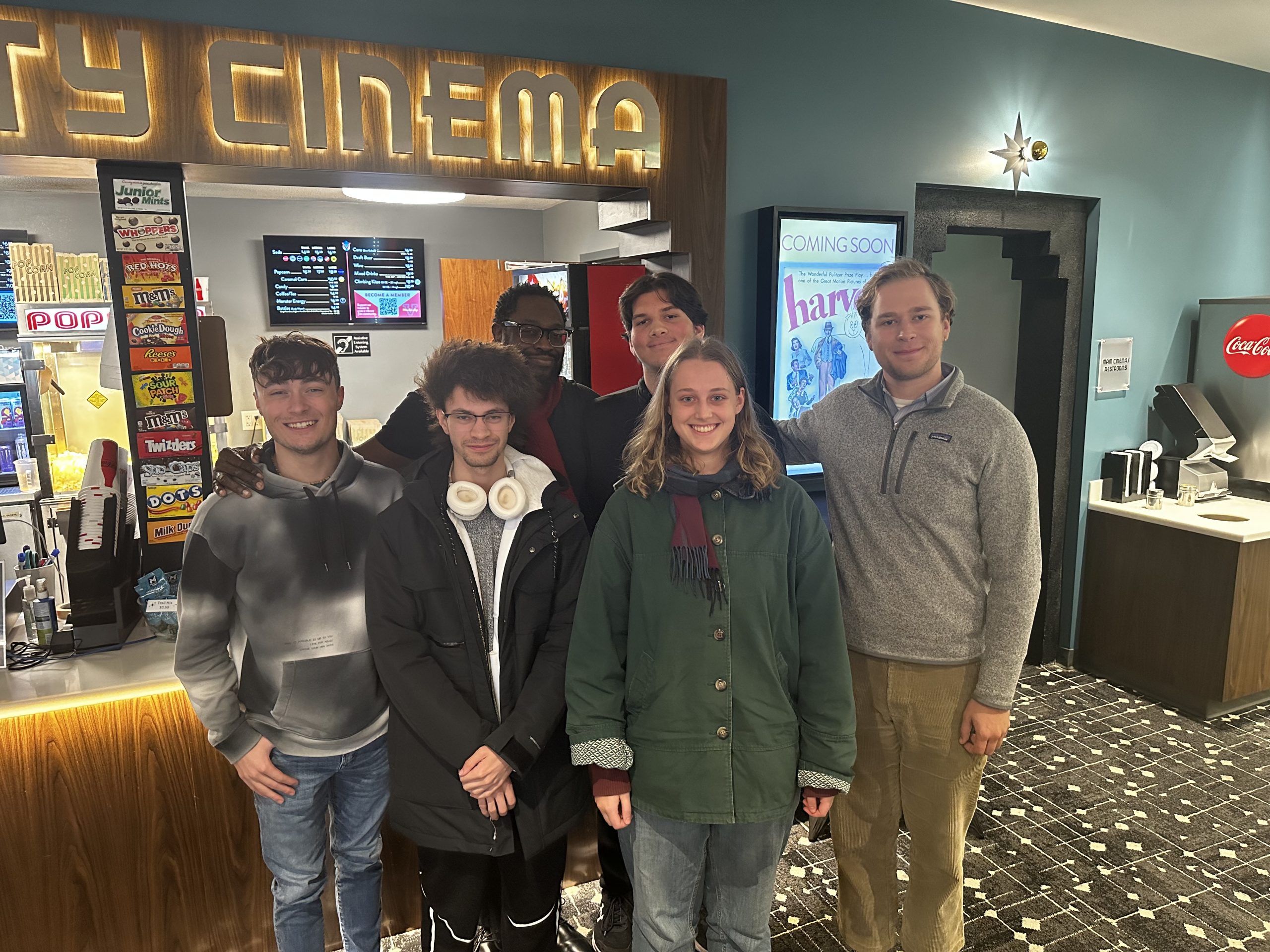 Group photo of Screenwriting Club members posing outside Varsity Cinema in Des Moines.