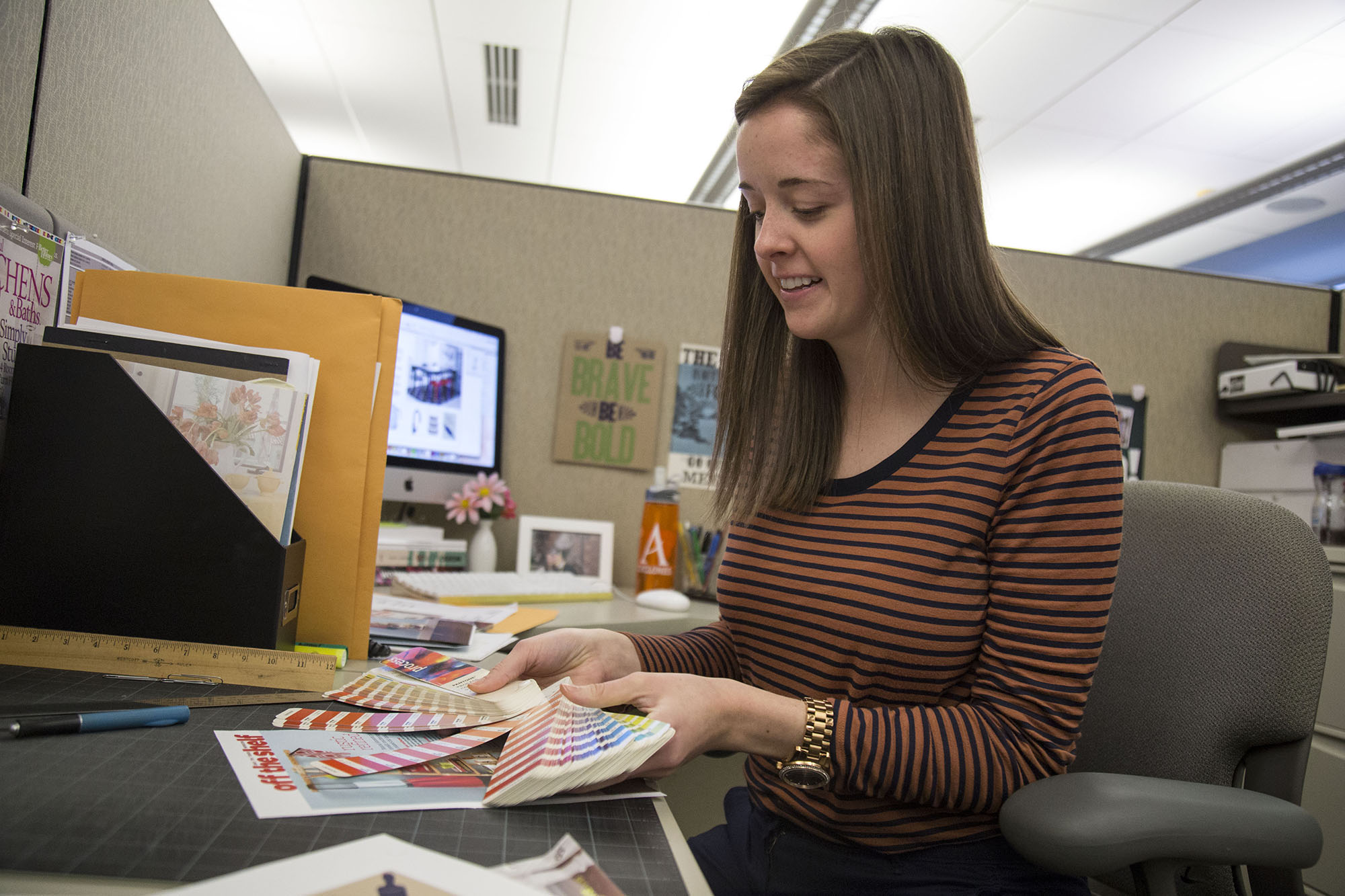 Allison Clem, design apprentice at SIM — Kitchen and Bath Makeovers, matches colors for a spread in the magazine’s upcoming issue.