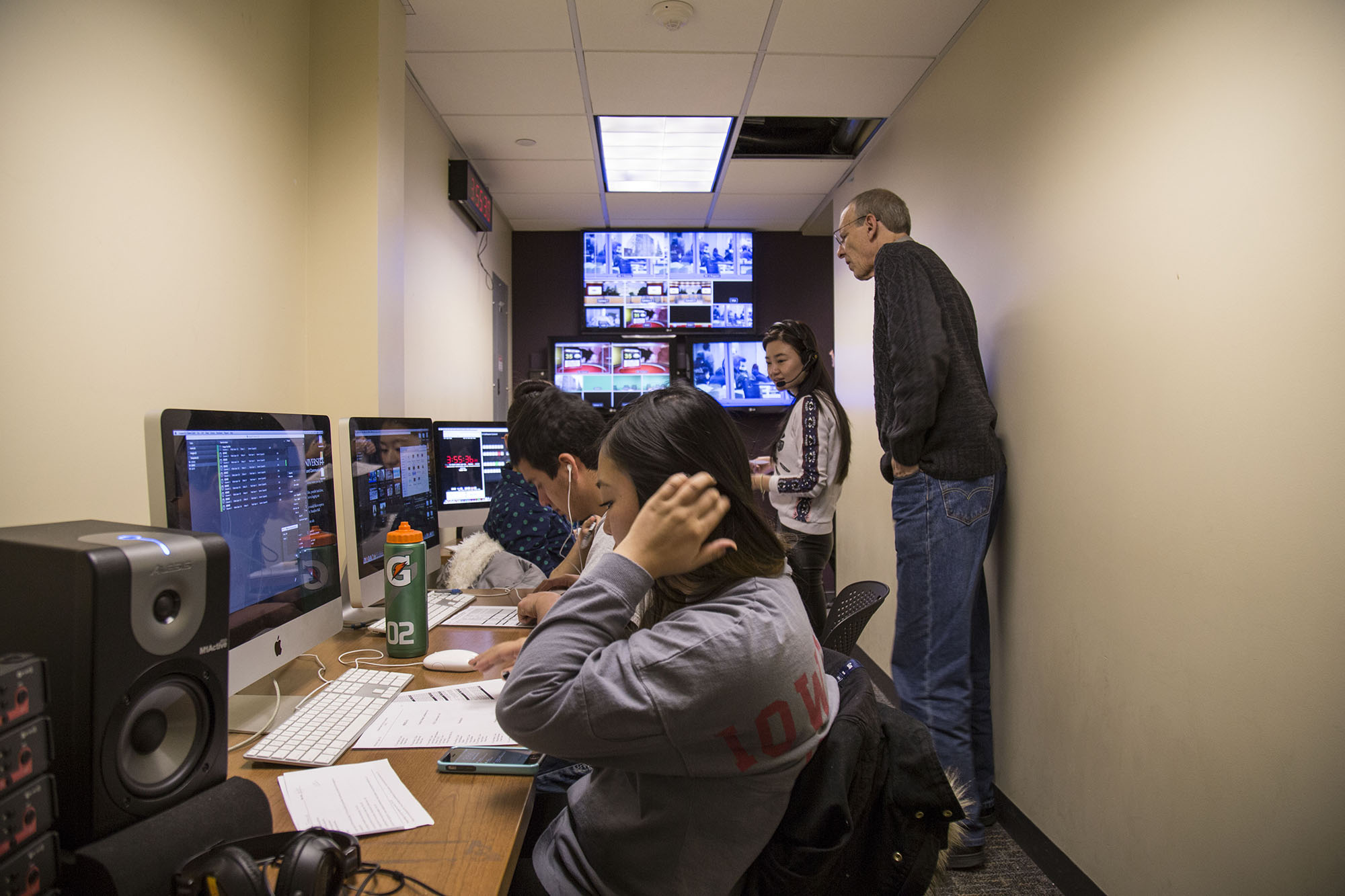 Jeff Ames, lecturer, monitors students in the studio’s control room during the filming of an episode of ISUtv. Photo by Matt Wettengel