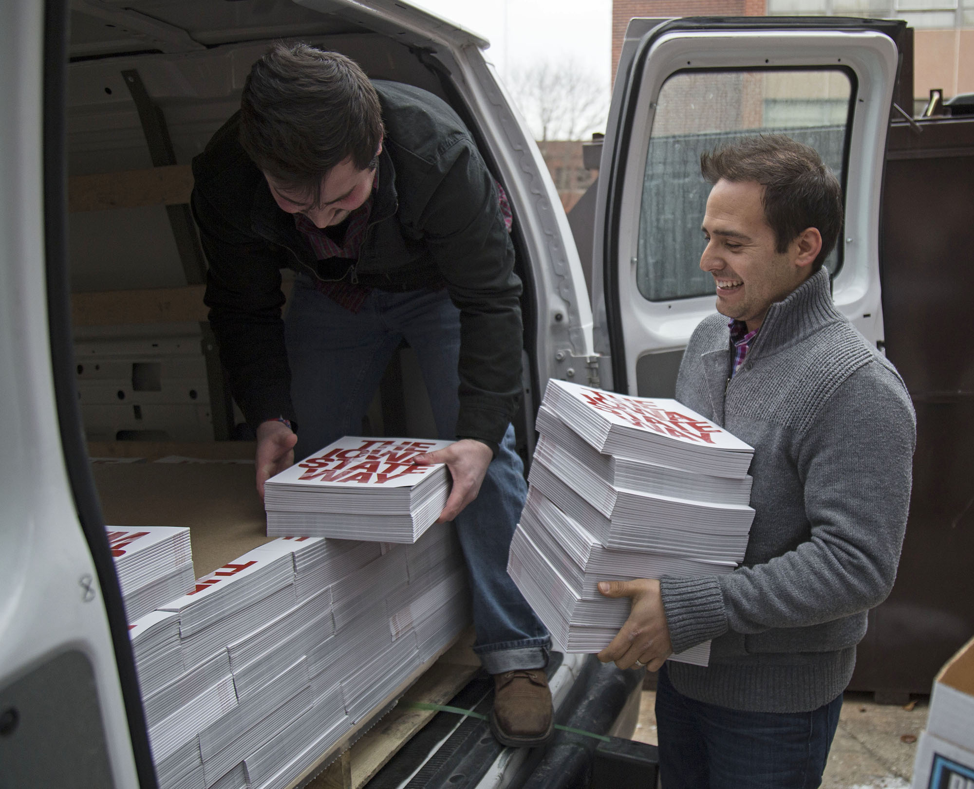 Lawrence Cunningham and Eric Fields, senior in advertising, distributing the Iowa State Daily