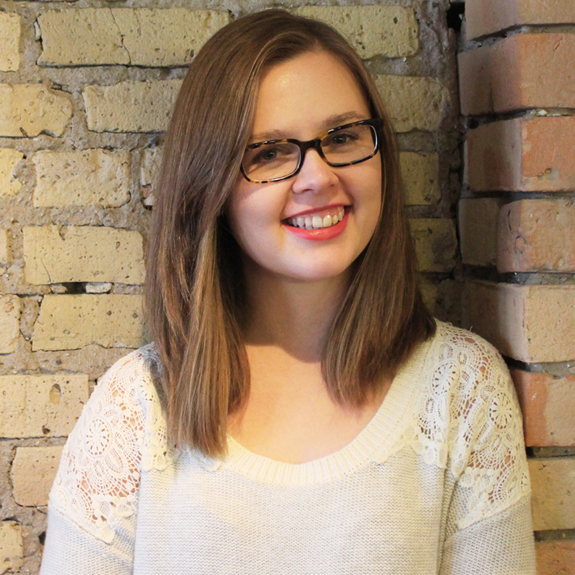 Megan Schuller smiles for the camera. She is wearing glasses and has brown hair.