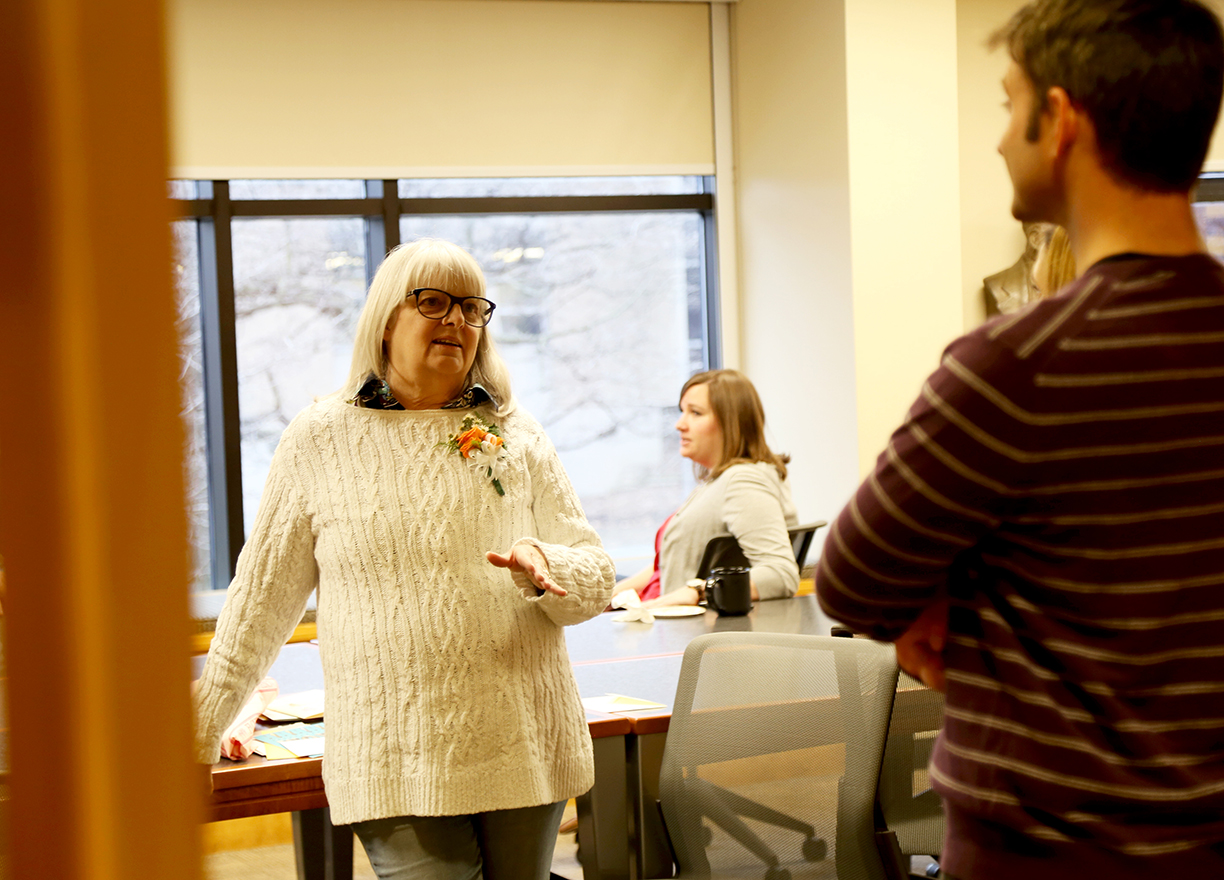 Kathy Box talks to guests at her retirement reception