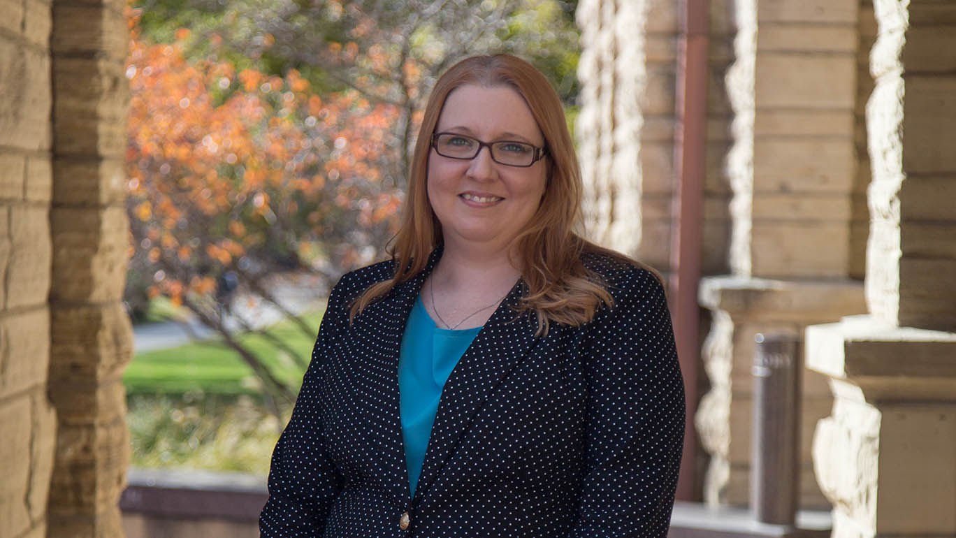 Kelly Winfrey stands outside Catt Hall on a fall day