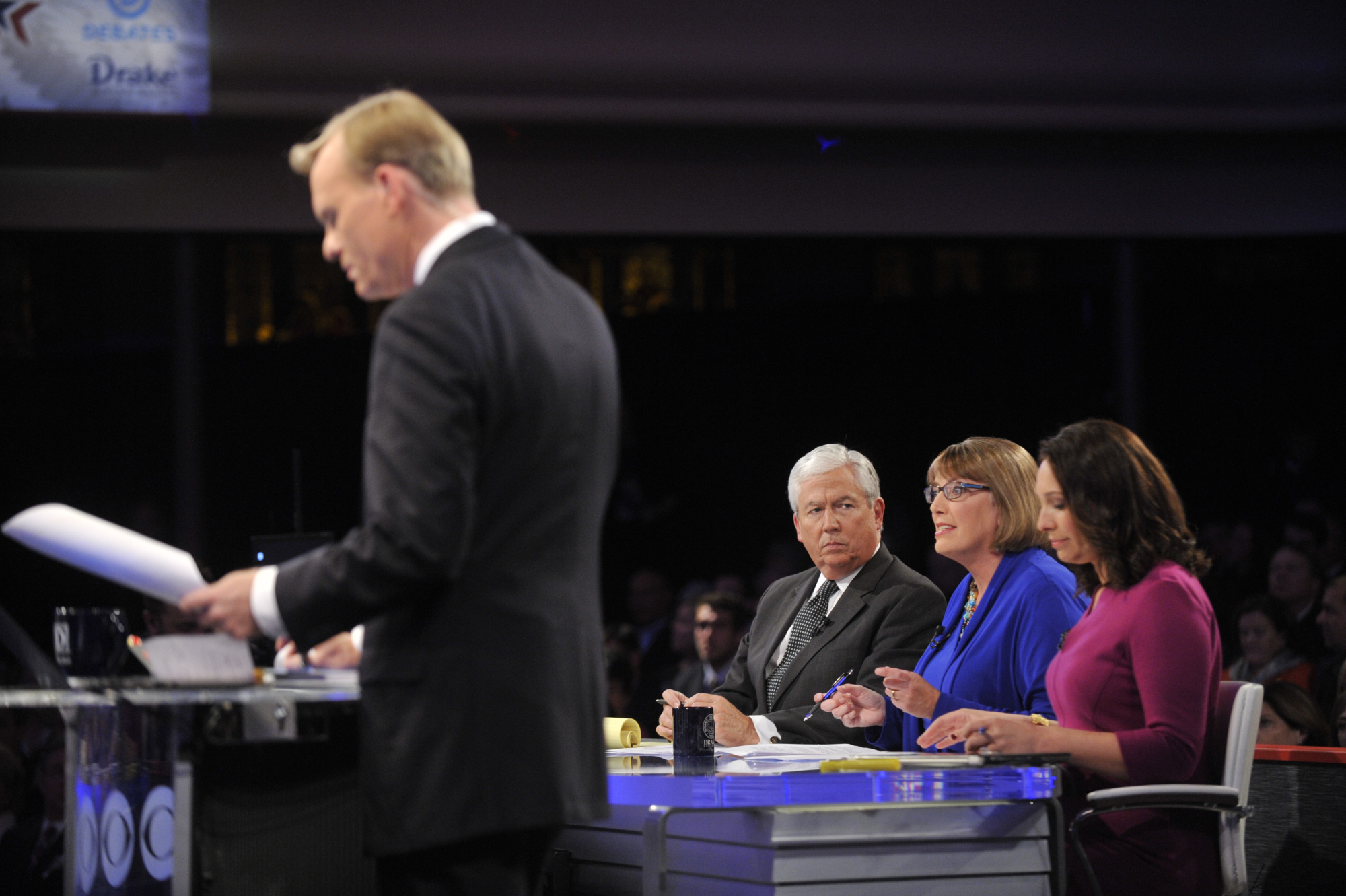 Kevin Cooney, ’74, and Kathie Obradovich, ’87, moderating at a Democratic Debate in Des Moines