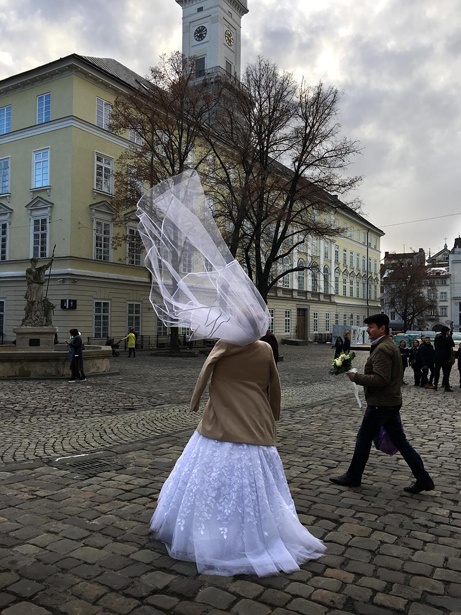 While waiting for a workshop to begin, Associate Professor Dennis Chamberlin captured a photo of a bride walking through Lviv Town Square. Photo by Dennis Chamberlin