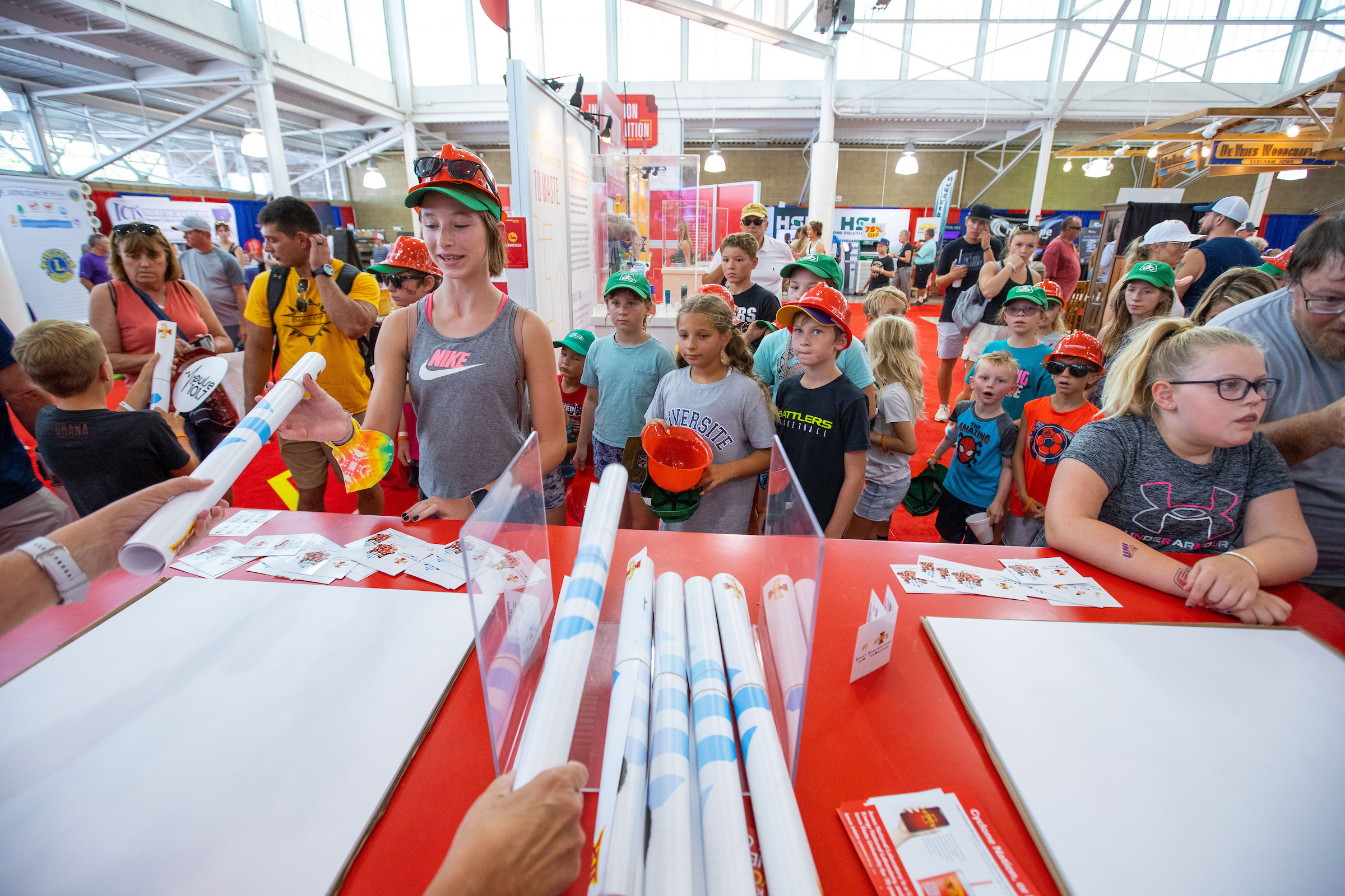 Visitors pick up posters at the ISU exhibit at the Iowa State Fair