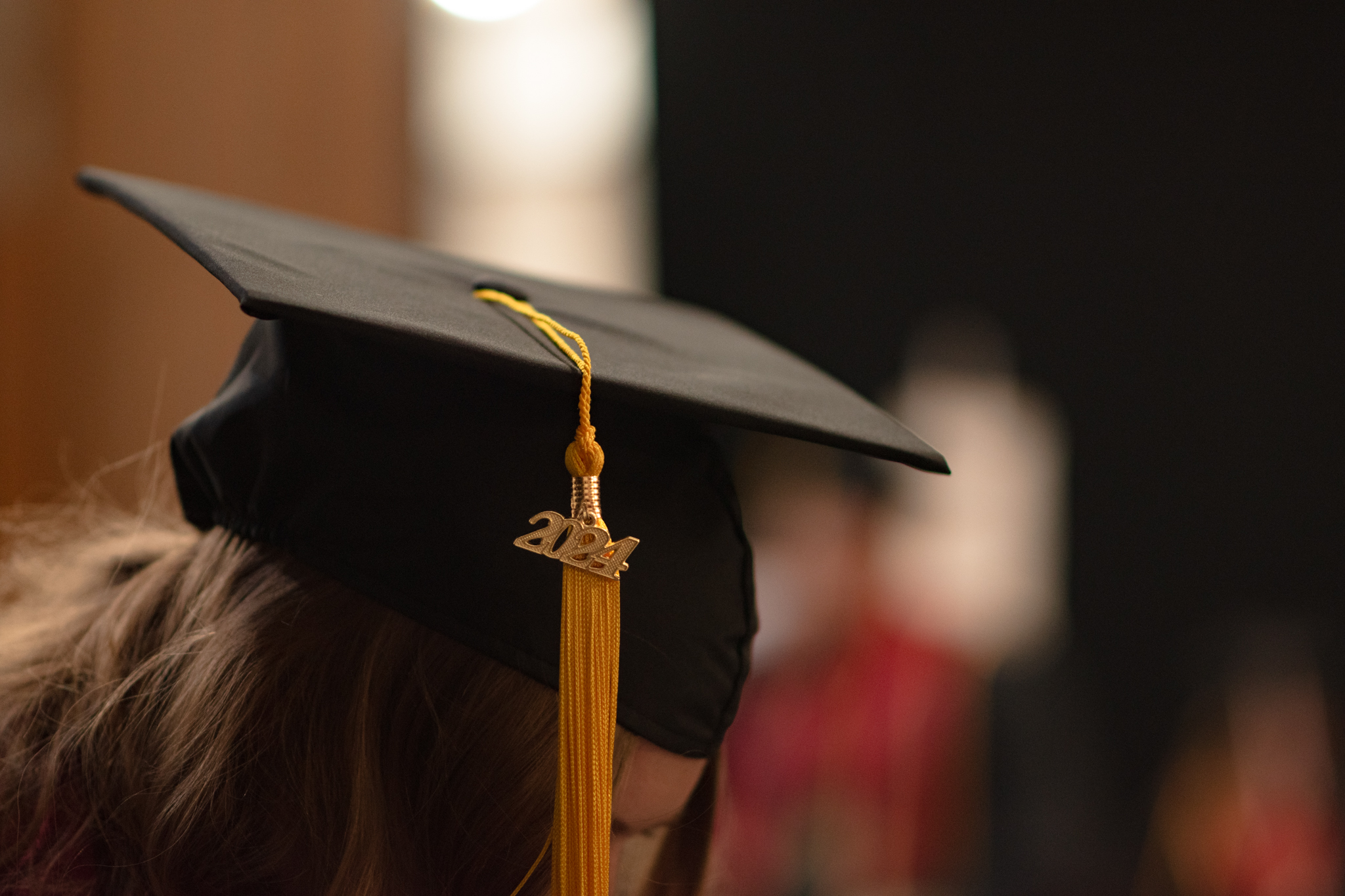 Close-up of student's graduation cap with a gold tassel hanging down with a "2024" charm attached.