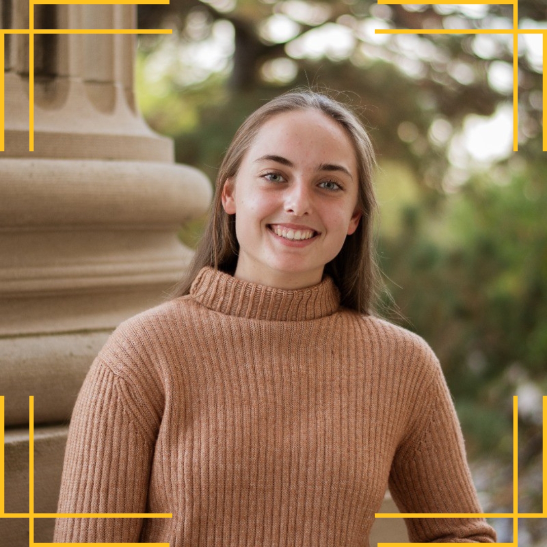 Elizabeth Quam (‘26 biochemistry) headshot outside of Beardshear Hall. She is wearing a brown knit turtleneck with an edited yellow frame around the image.