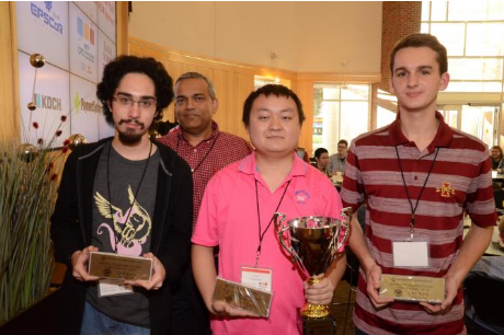 Three computer science students hold their trophies from a programming competition.