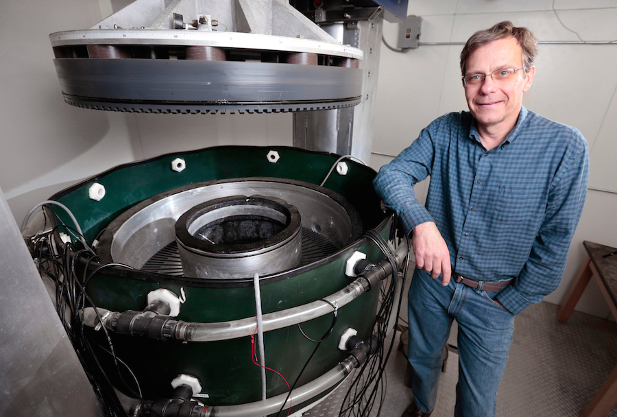 Neal Iverson rests his arm on the glacial sliding simulator he designed.