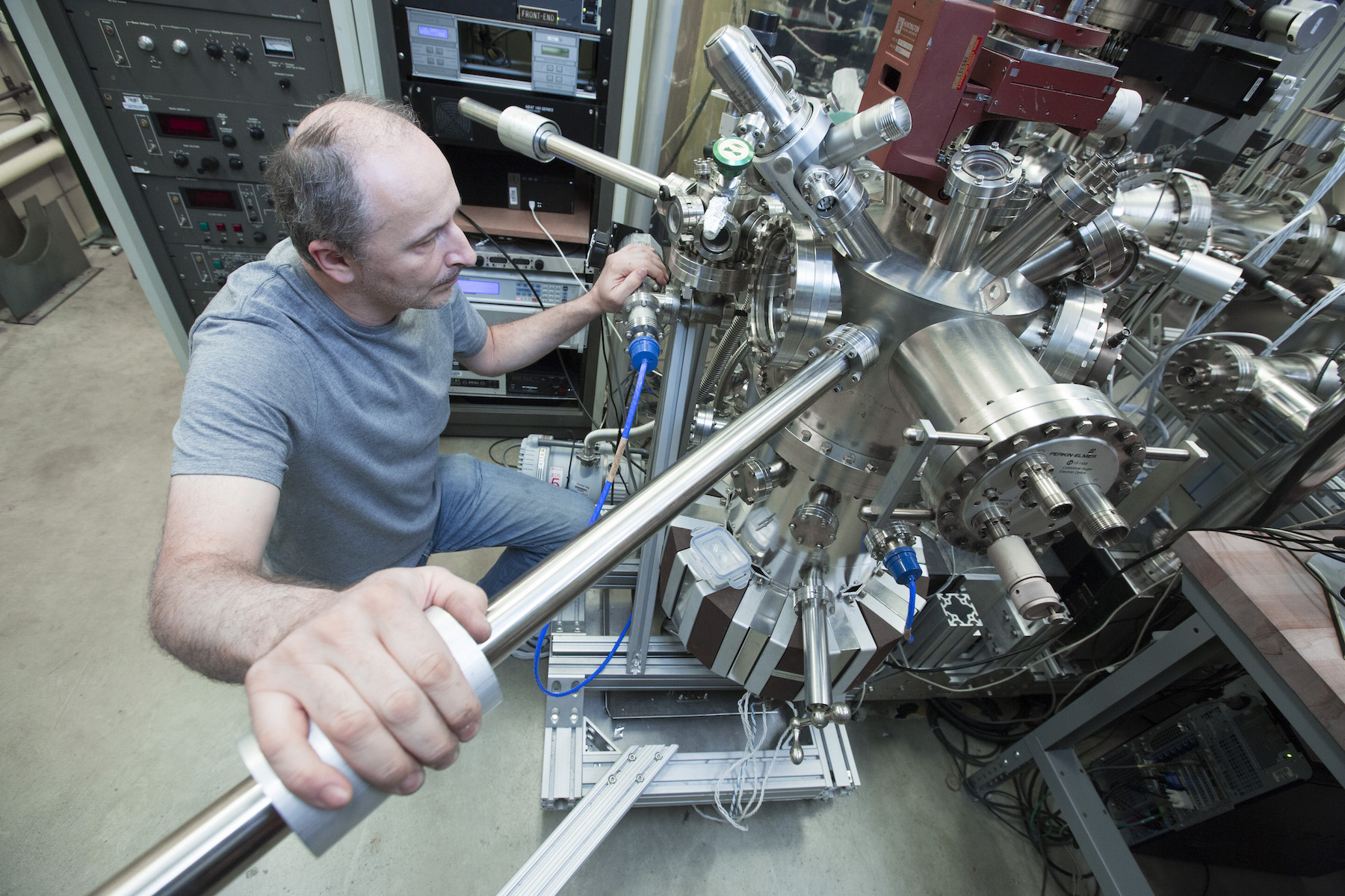 Adam Kaminski looks through a viewing pane into his machine.