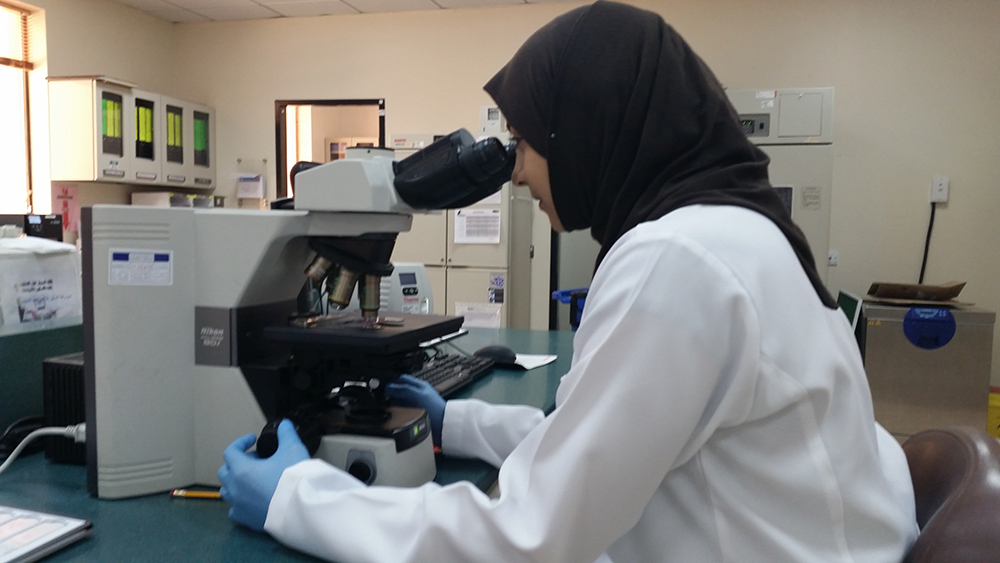 Majd Abdulghani with microscope