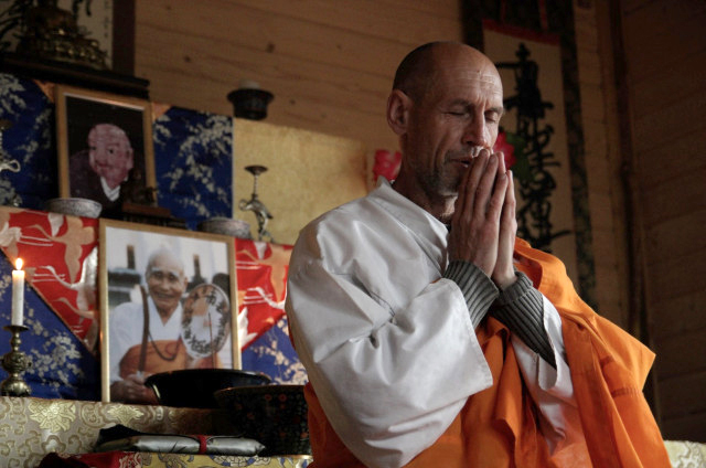 A monk prays intently in western Ukraine