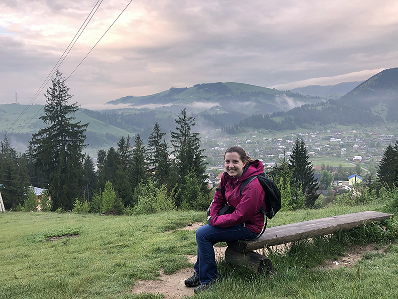 Student sits on a bench on a mountain in Lviv