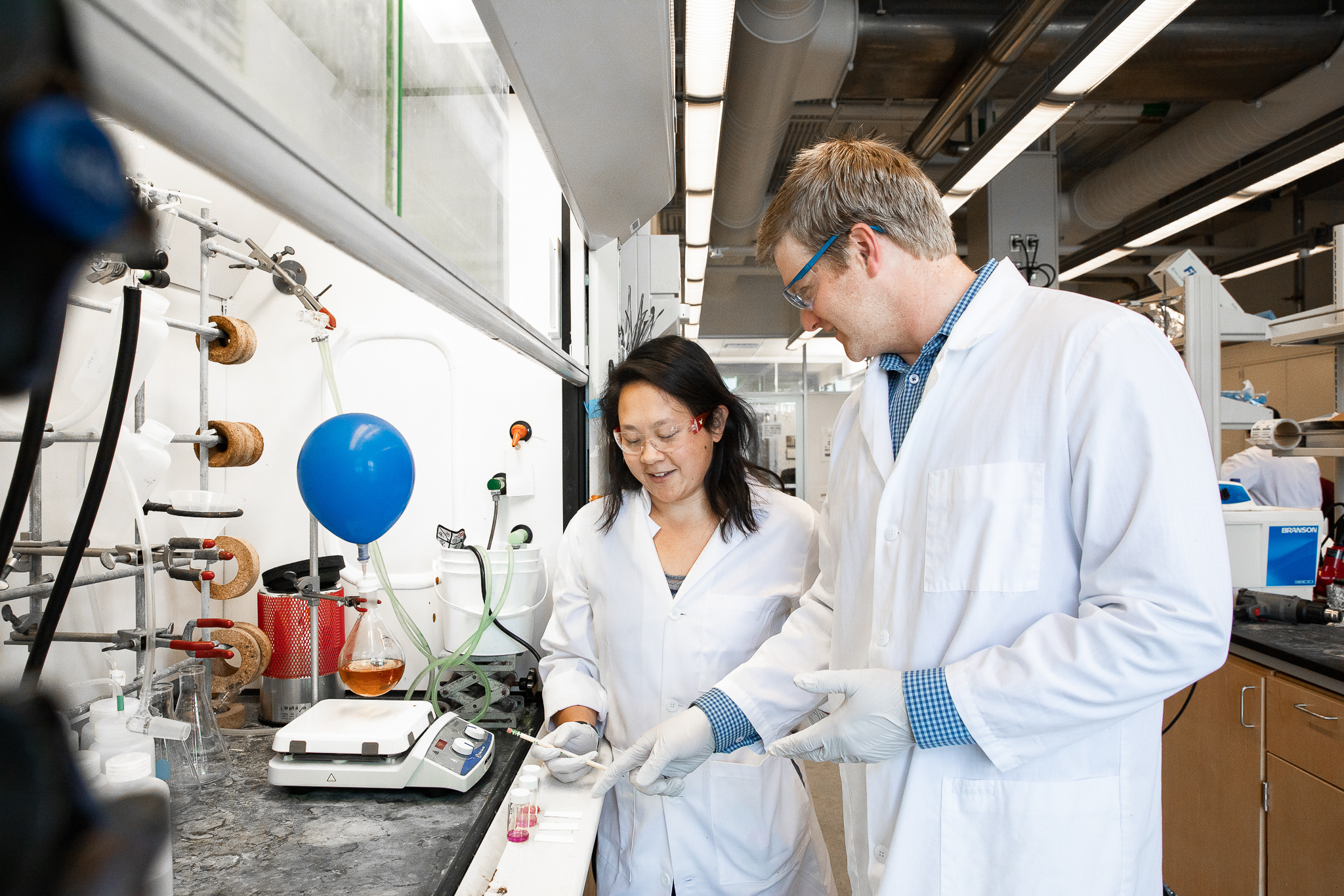 Dr. VanVeller and one of his student researchers work in the lab