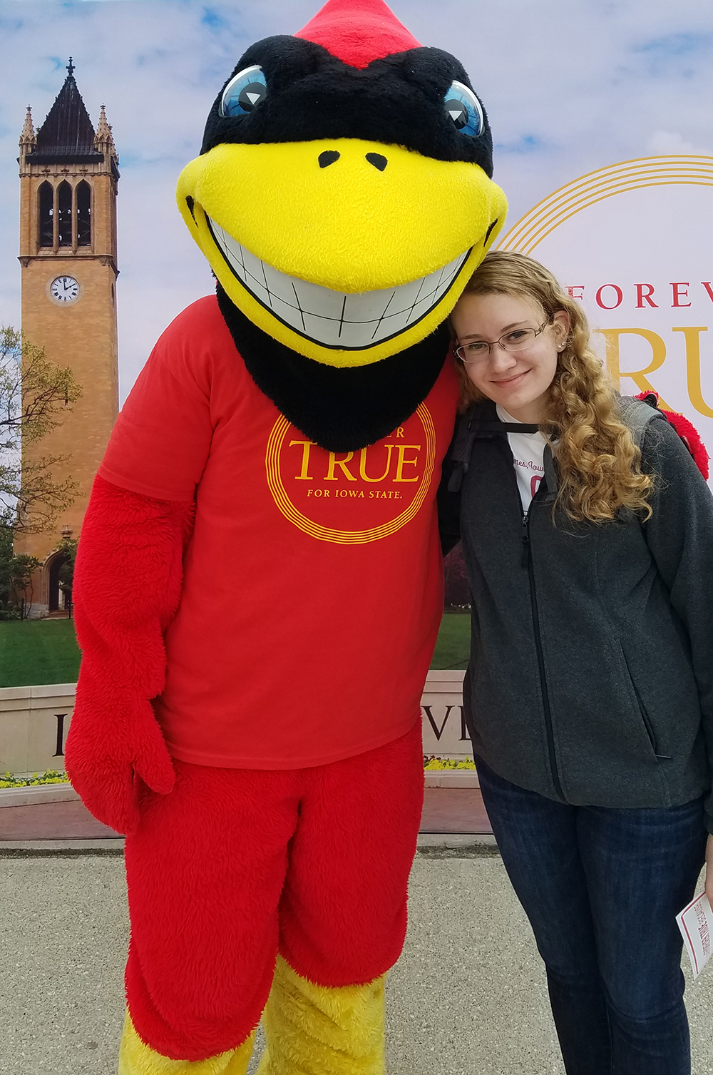 Student Sarah Zelle poses with mascot Cy