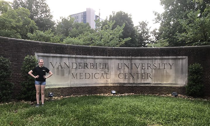 Student Sarah Zelle poses in front of the Vanderbilt University Medical Center sign