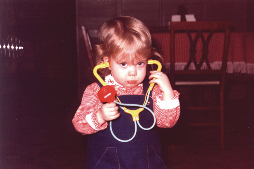 Robbyn Anand as a young child playing with a toy stethoscope