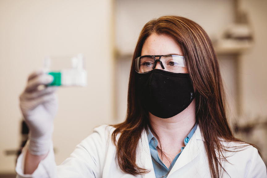 Robbyn Anand holds a container full of antibodies which will be used in the development of her COVID-19 test.