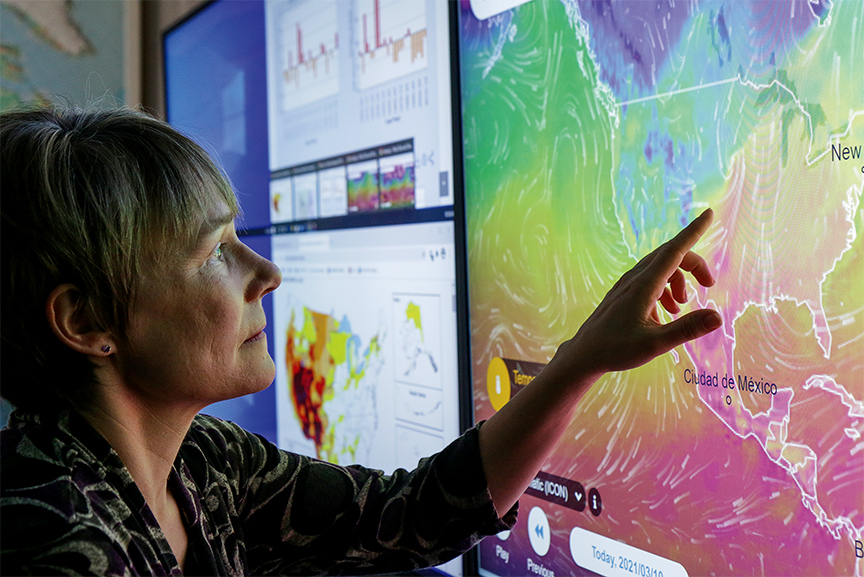 Kristie Franz examines a weather map.
