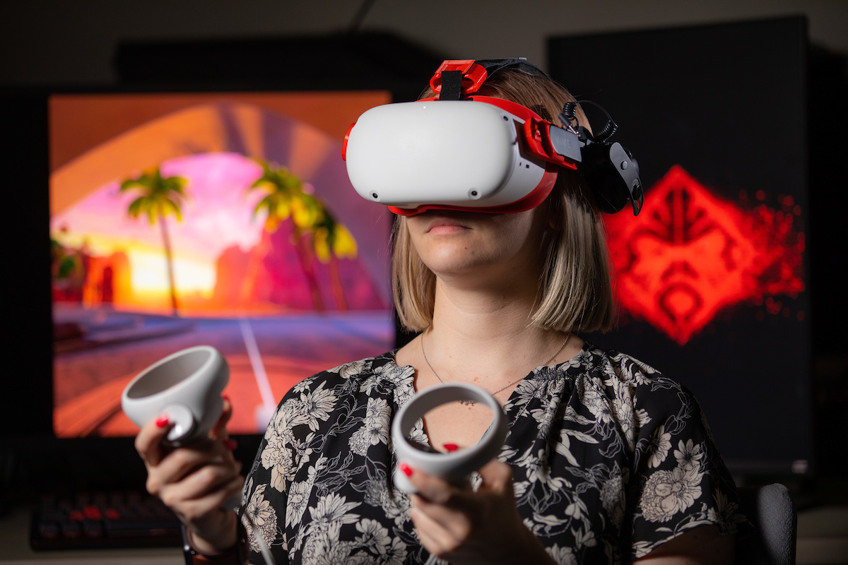 Psychology grad student Taylor Doty in a VR headset.  (Christopher Gannon/Iowa State University)
