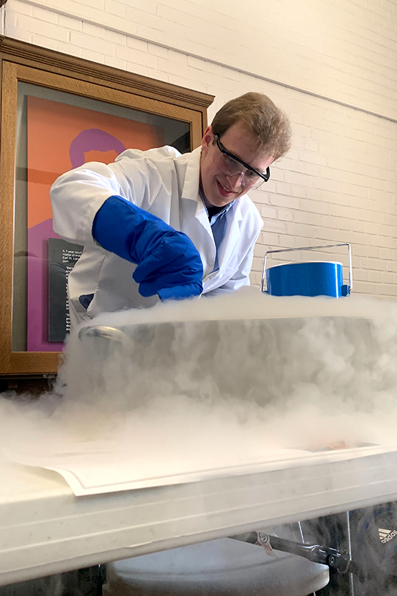 Student working with dry ice on a table