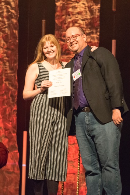 Associate professor of theatre Brad Dell presents Taylor Millar with her first place Society of Directors and Choreographers directing award.
