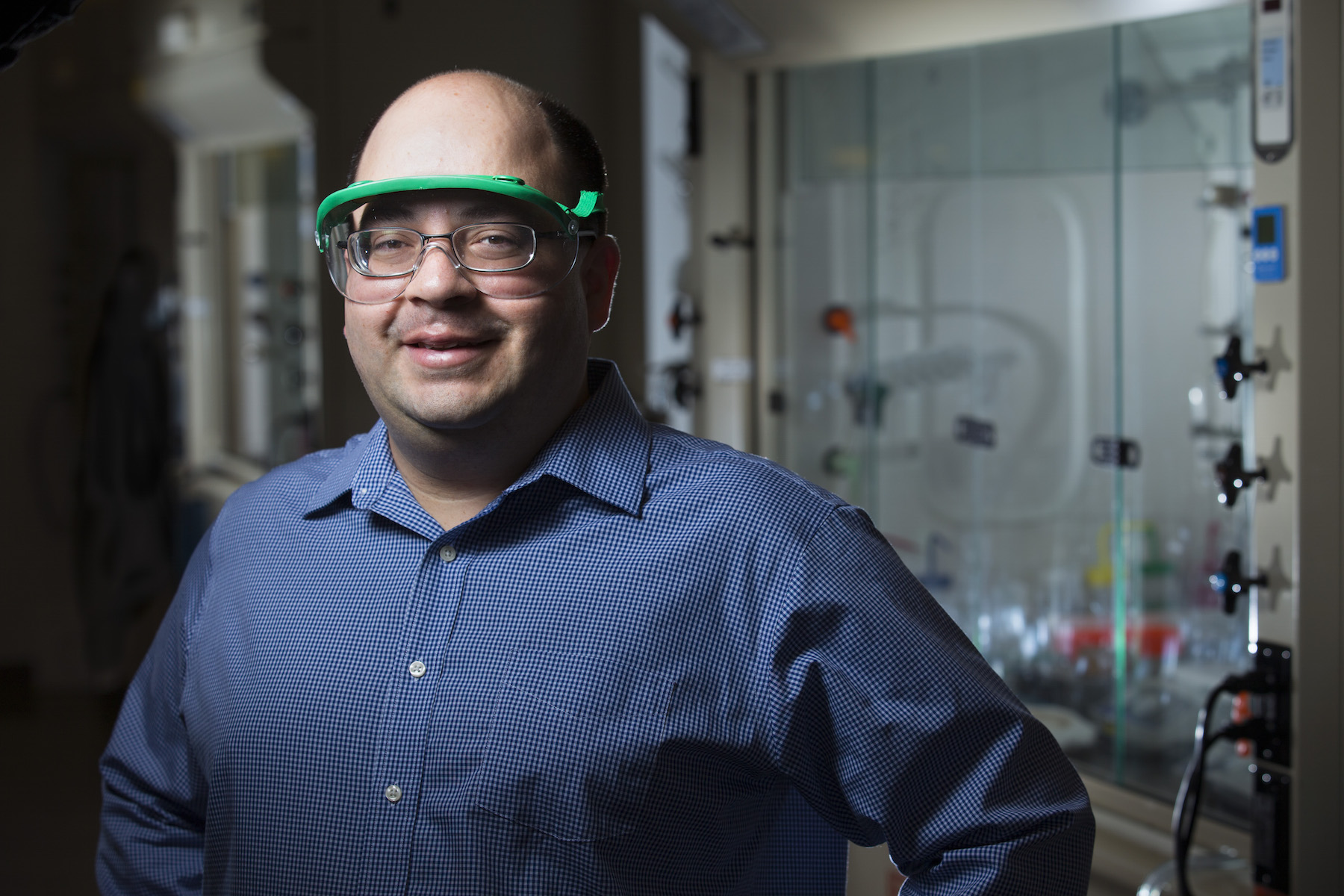 Javier Vela stands in a chemistry lab.