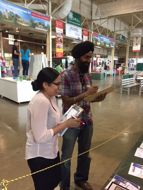 Geetu Tuteja, left, and Ranpal Dosanjh judge 4-H projects at the 2017 Iowa State Fair.