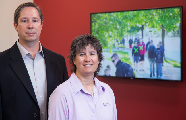 The video on the monitor is one that Christian Meissner (left) and Dawn Sweet (right) created to test how well police officers can detect if someone is concealing a weapon. Photo by Christopher Gannon.