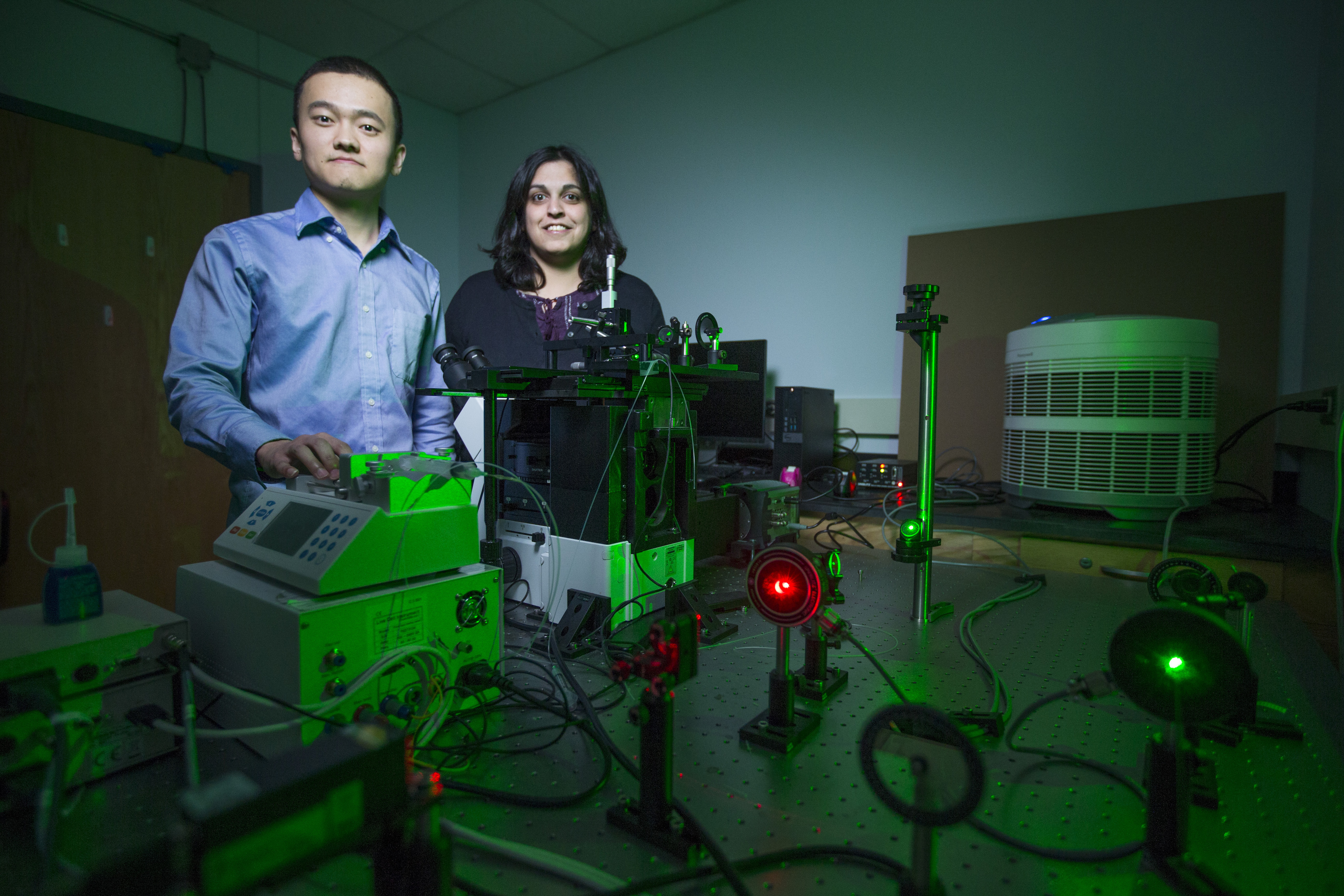 Chaoyou Xue and Dipali Sashital with the laser which enabled the visualization of how CRISPR proteins search DNA. (Christopher Gannon/Iowa State University)