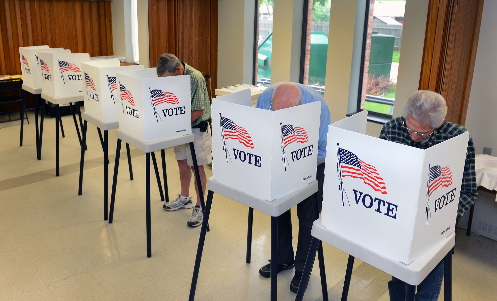 Voters vote in private booths.