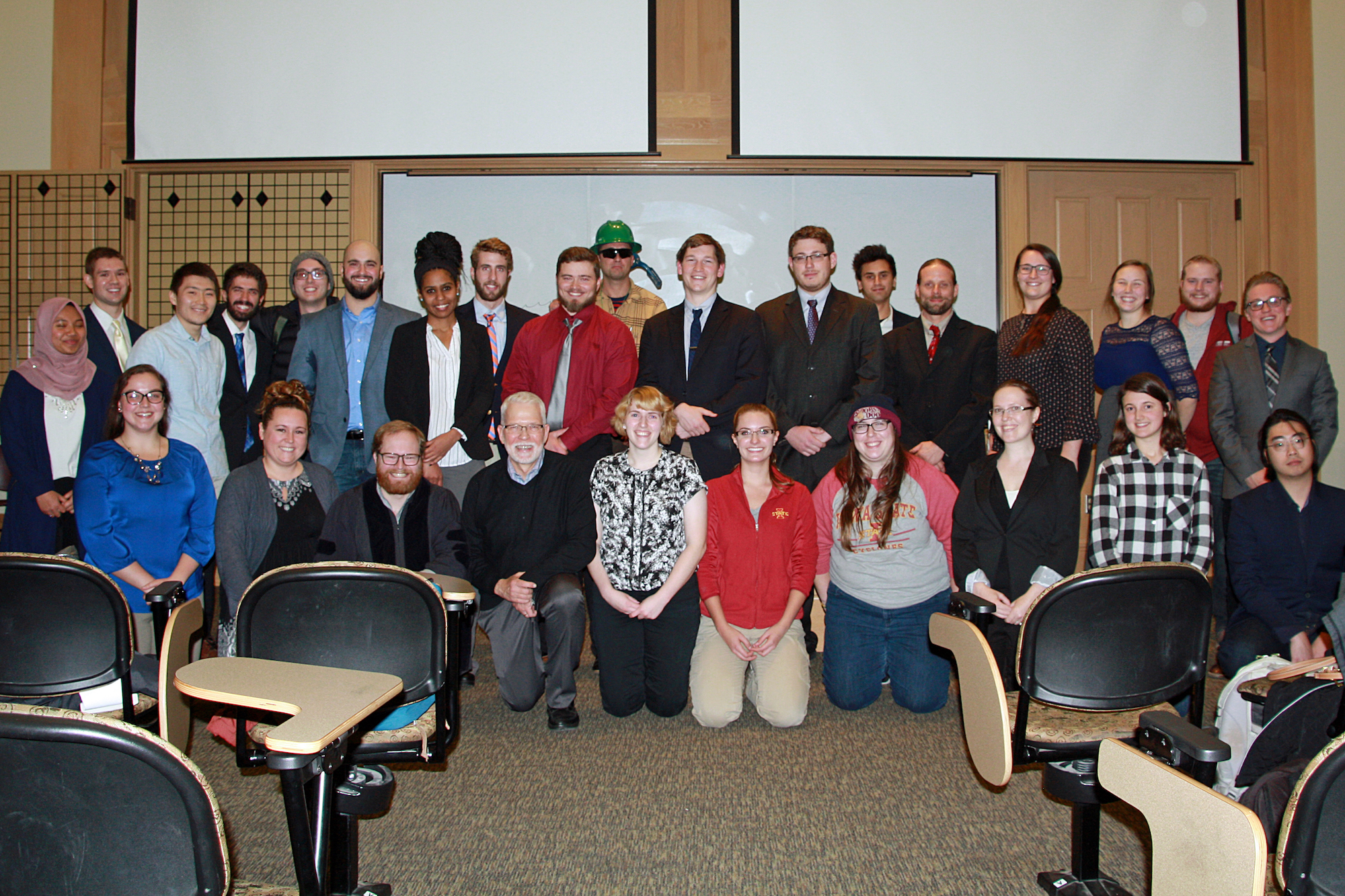 Students and faculty pose in two rows.