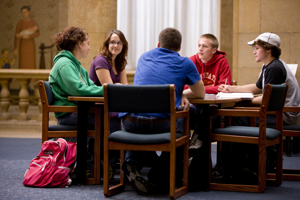 Five students studying in a library