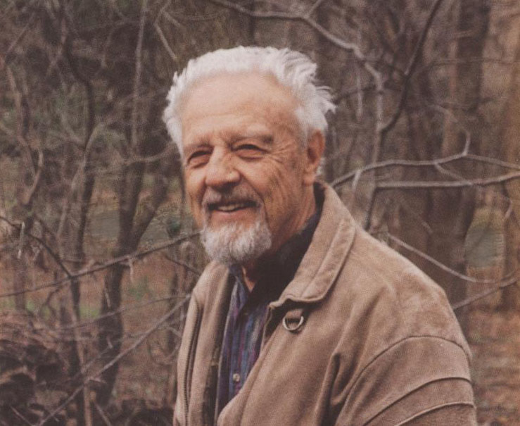 A photo of Klaus Ruedenberg outside in the woods in the fall.