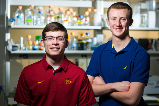 Two men stand in a laboratory.