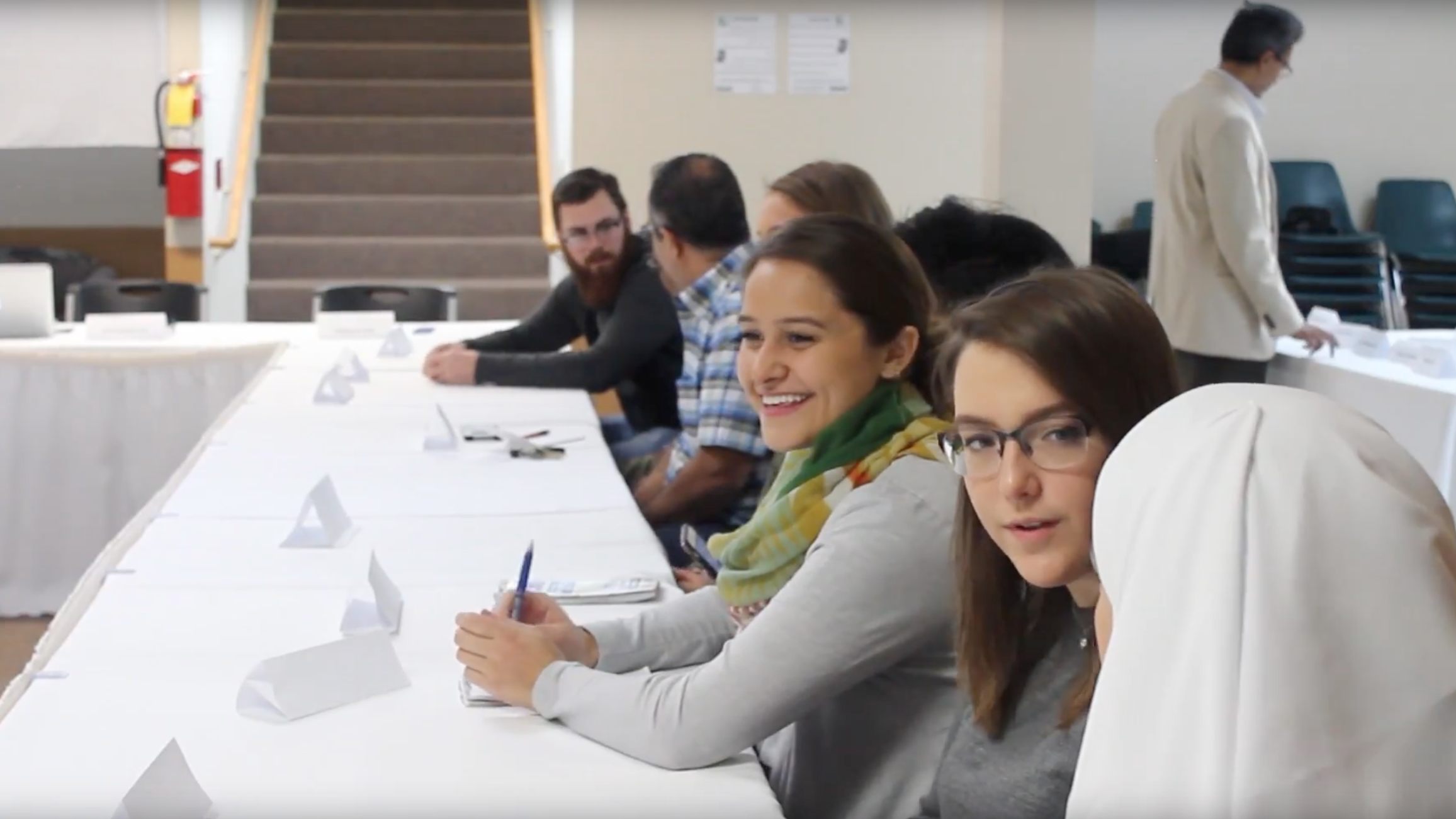 Students sit together at a table.