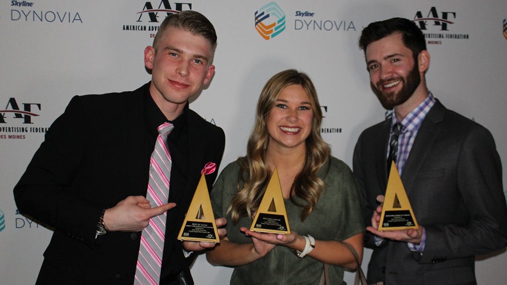 Students show off their awards for the American Advertising Awards.