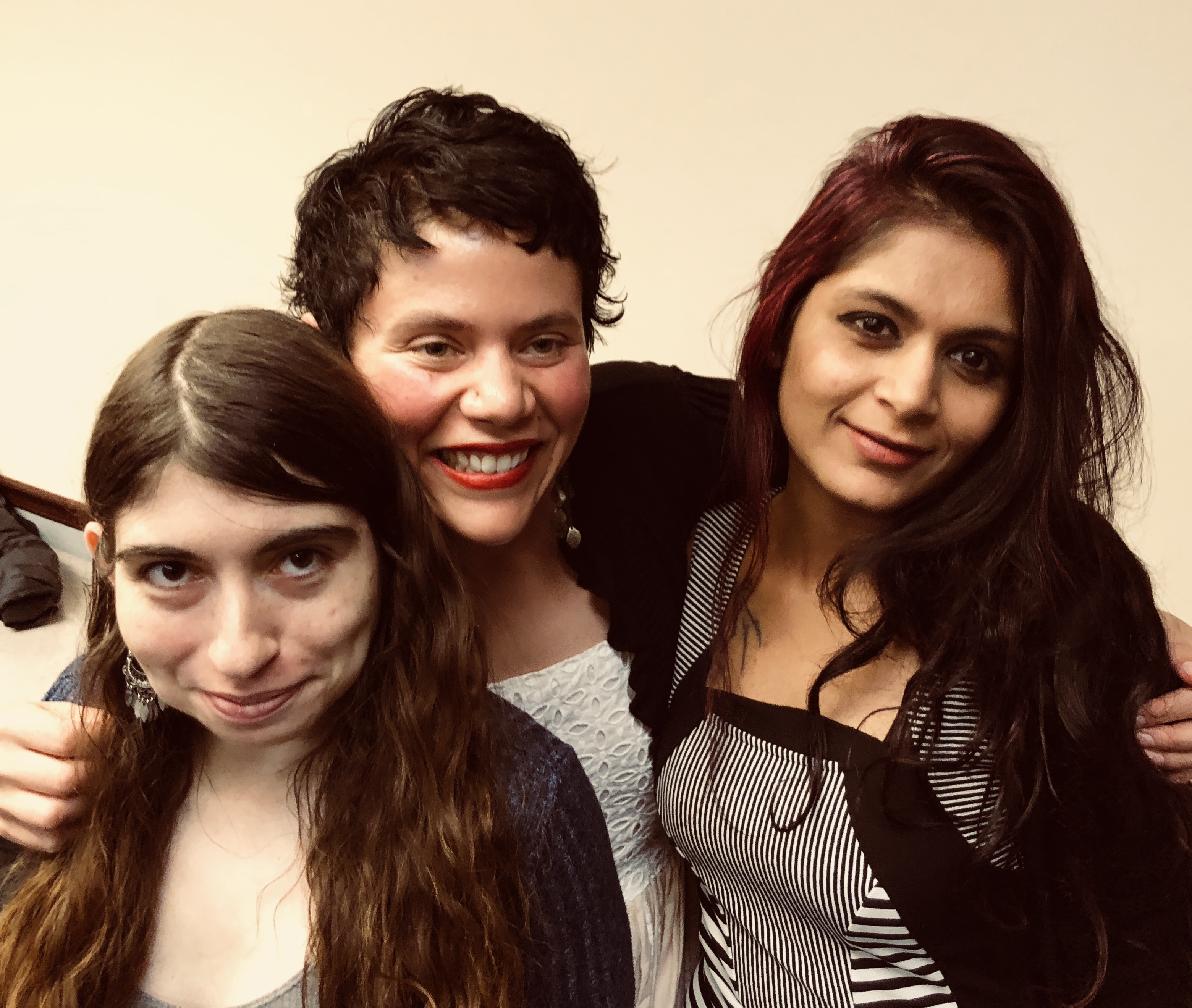 Three graduate students pose for a group shot.