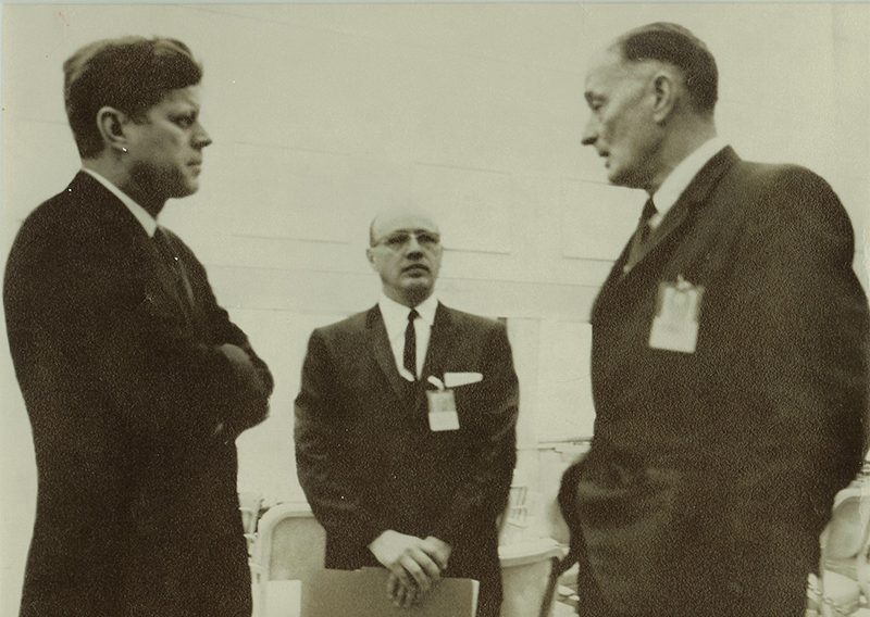 a black and white photo shows Dwight with President Kennedy