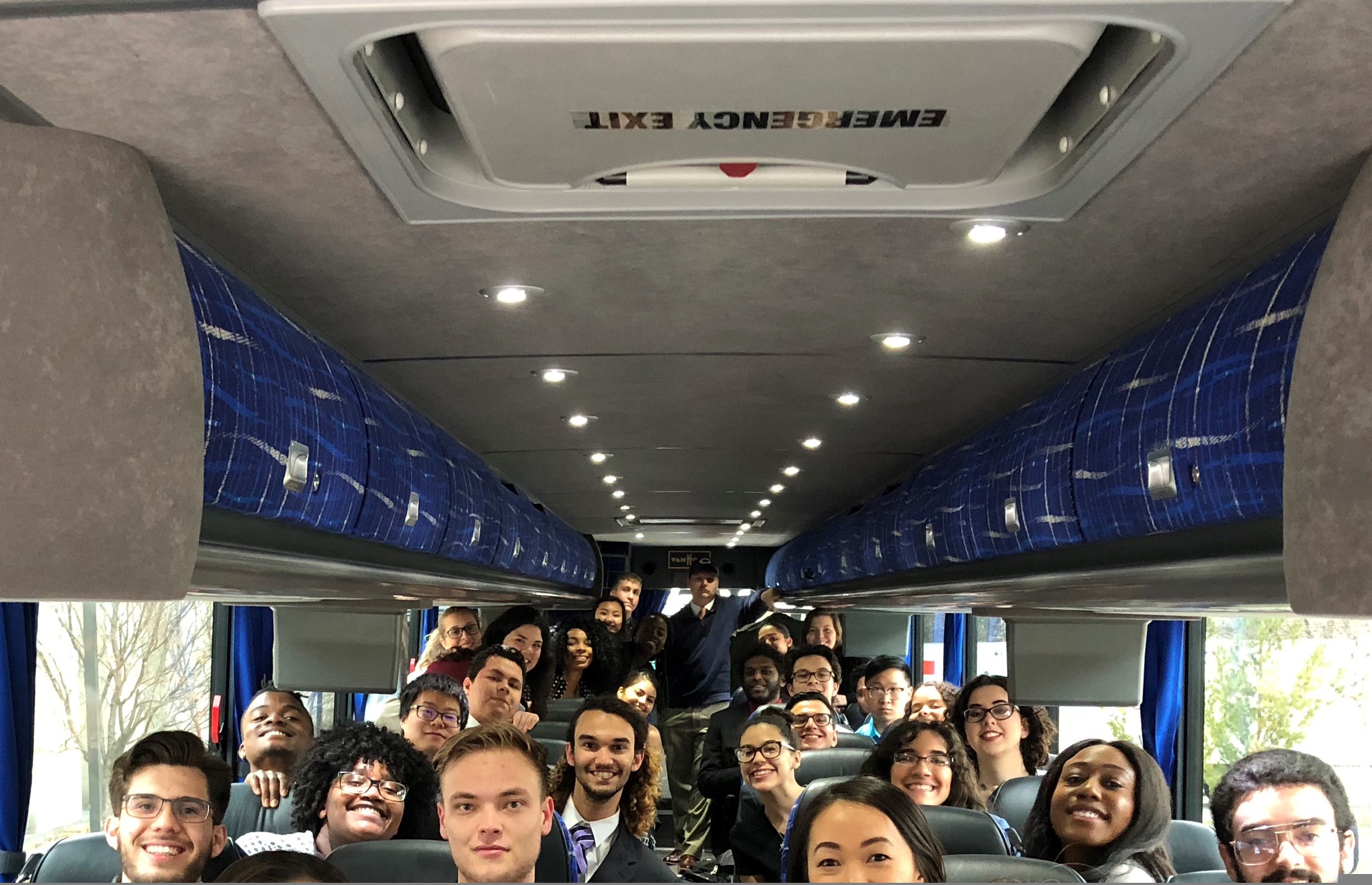 ISU students seated inside a bus for a field trip.